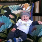baby on floral upholstered chair